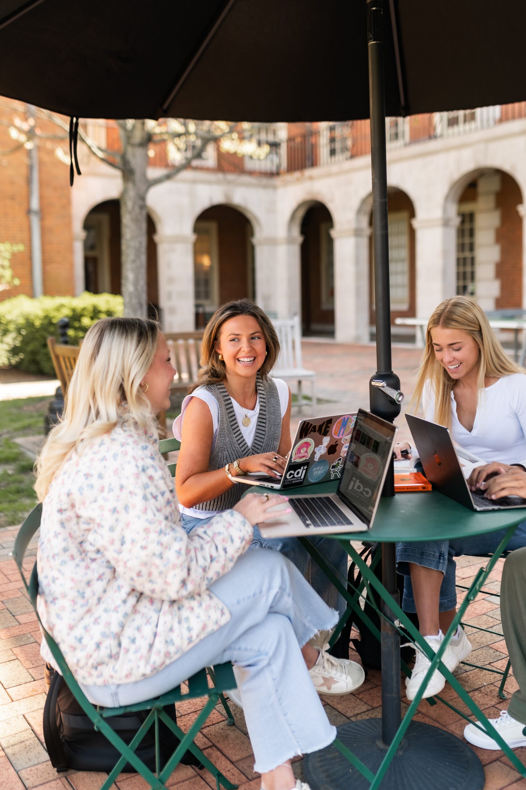 college students studying at patio table scaled