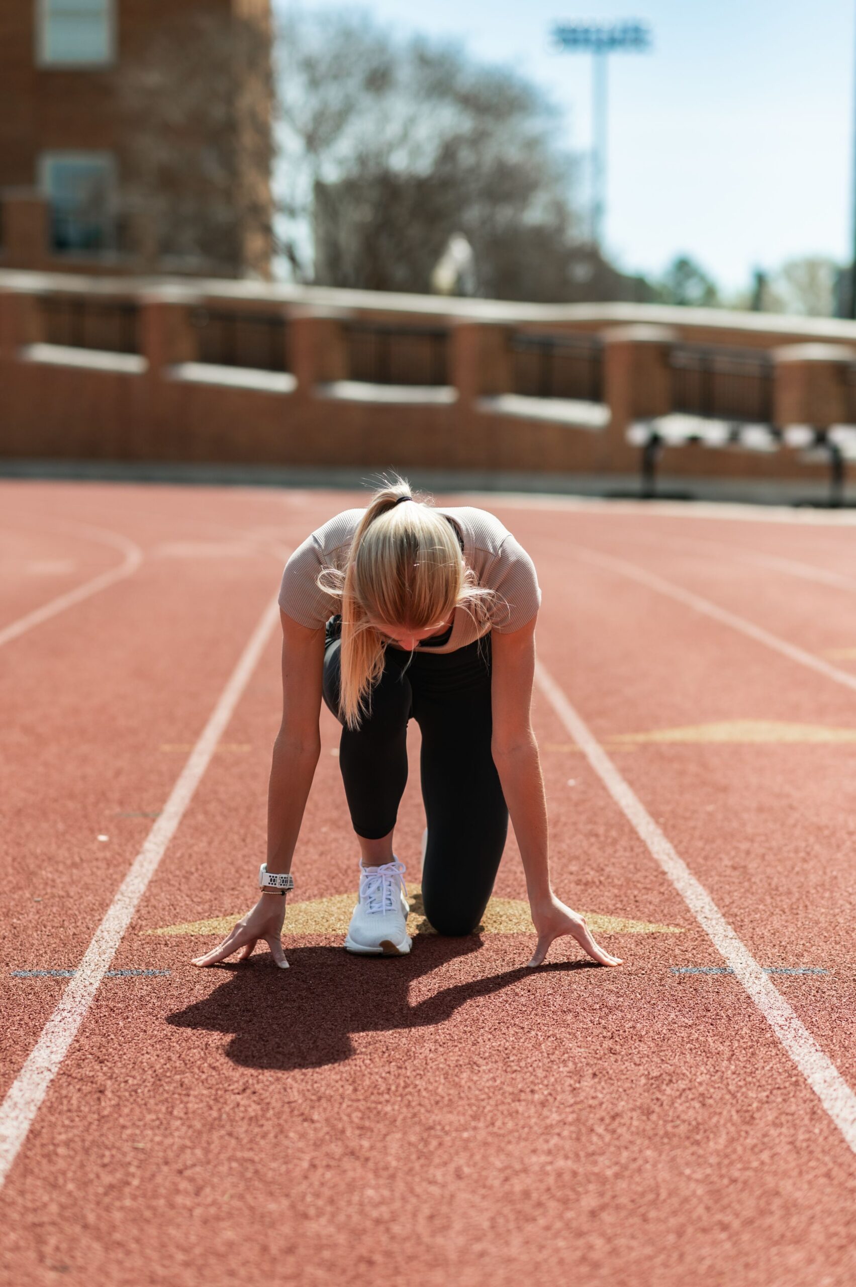 female sprinter at starting line scaled