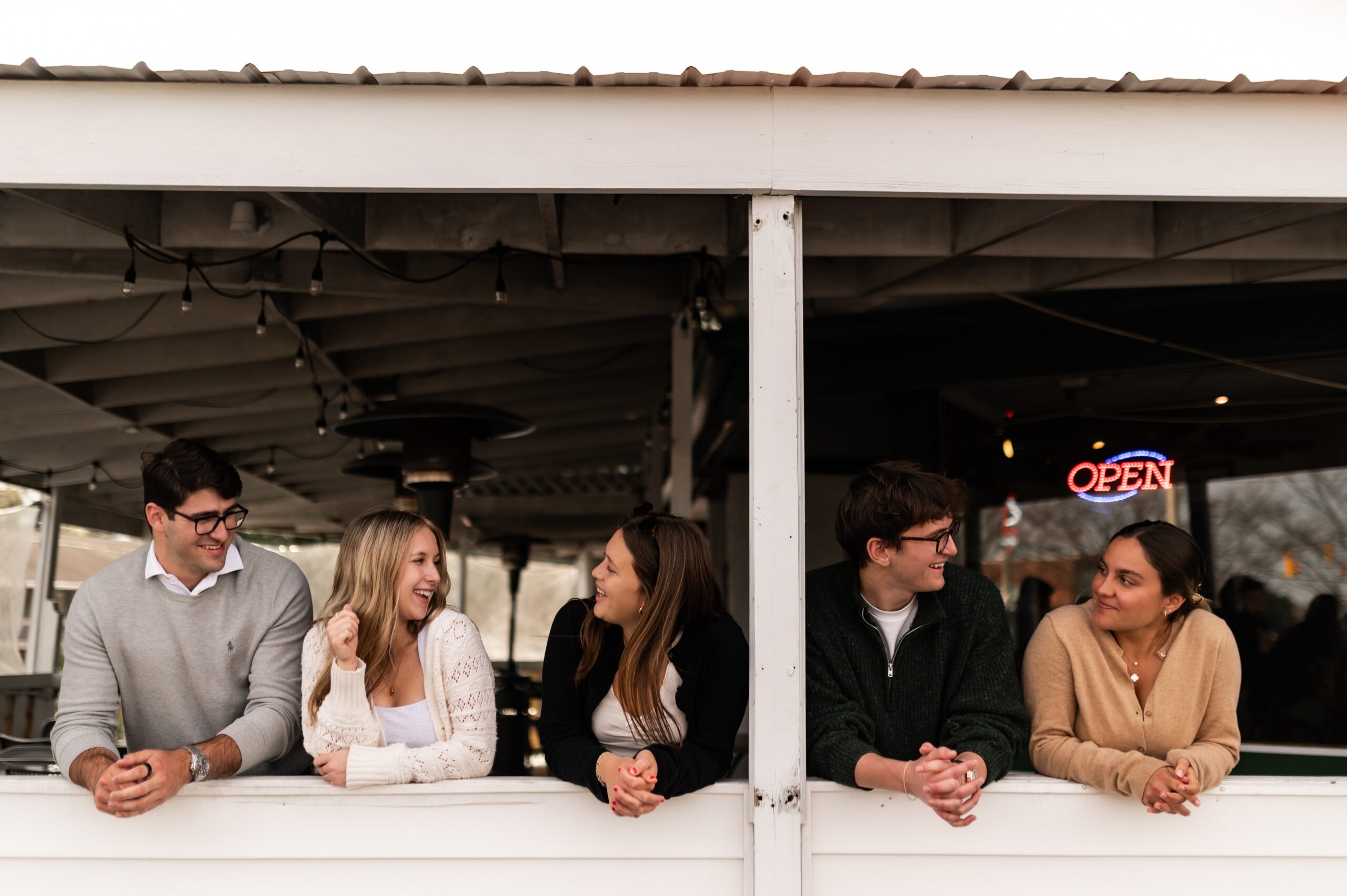 friends conversing at outdoor restaurant patio scaled