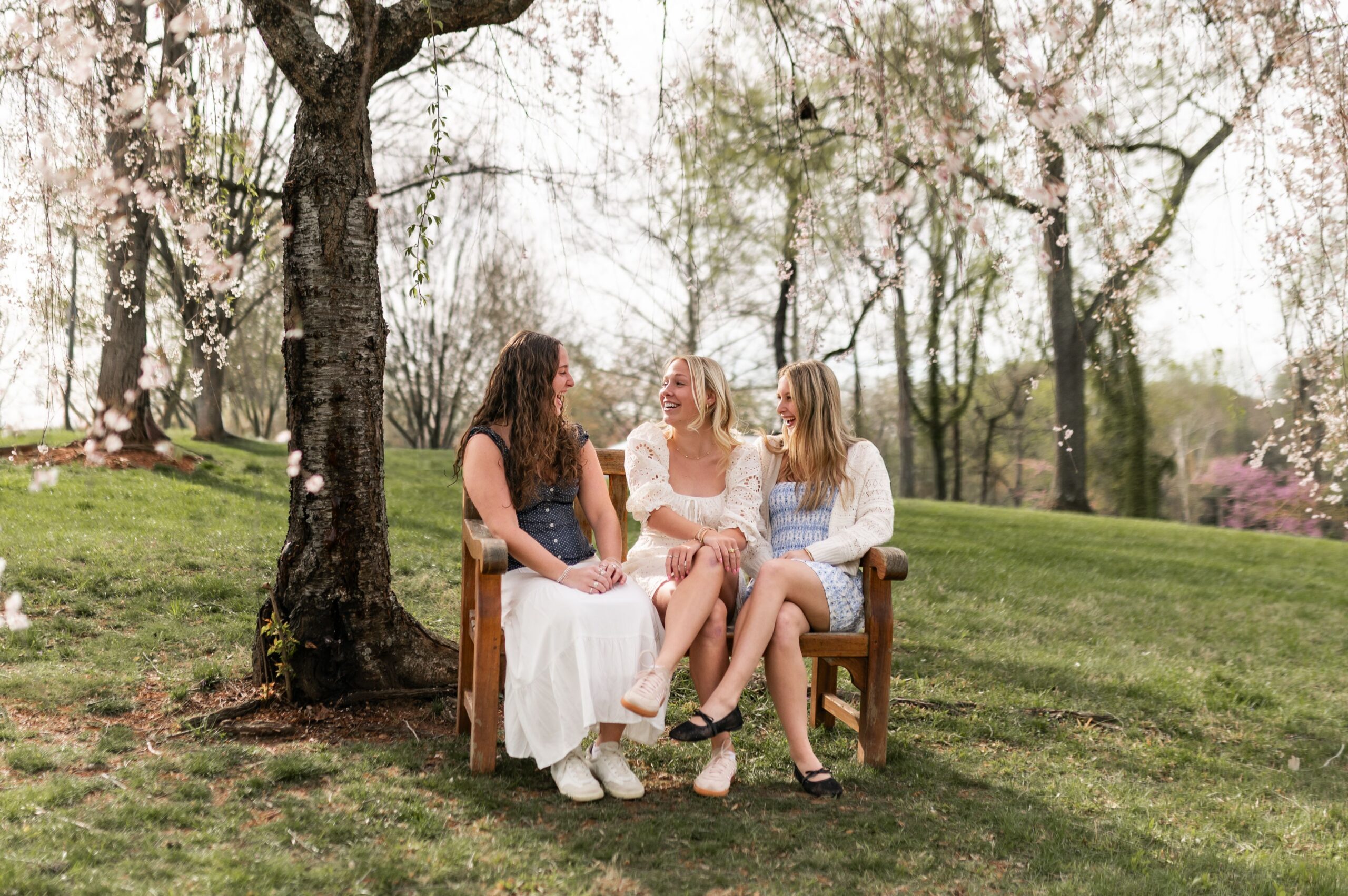 friends sharing laughs in blooming park scaled