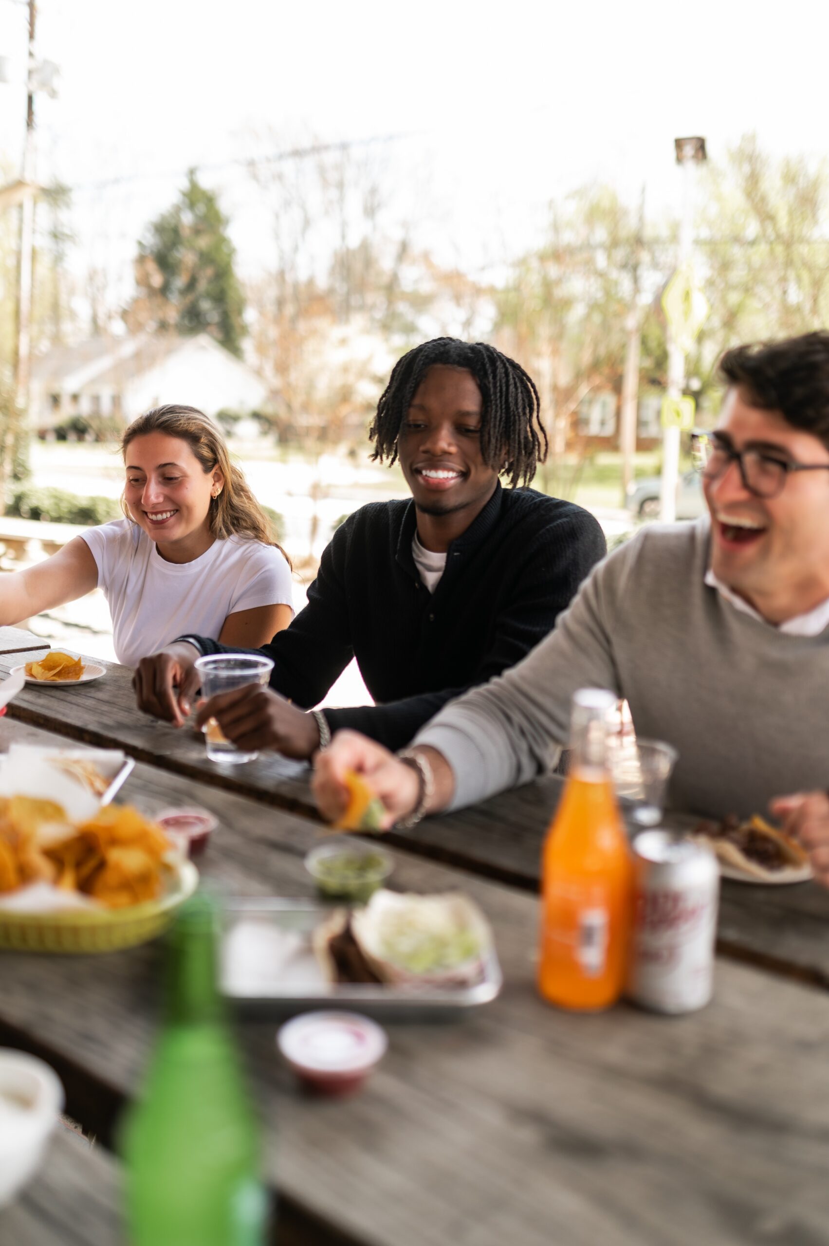 friends sharing meal at picnic table scaled