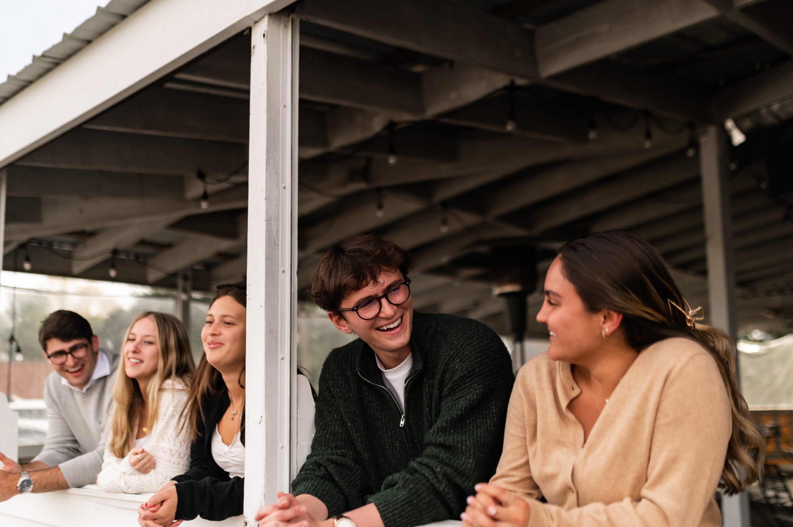 group of friends socializing on deck scaled