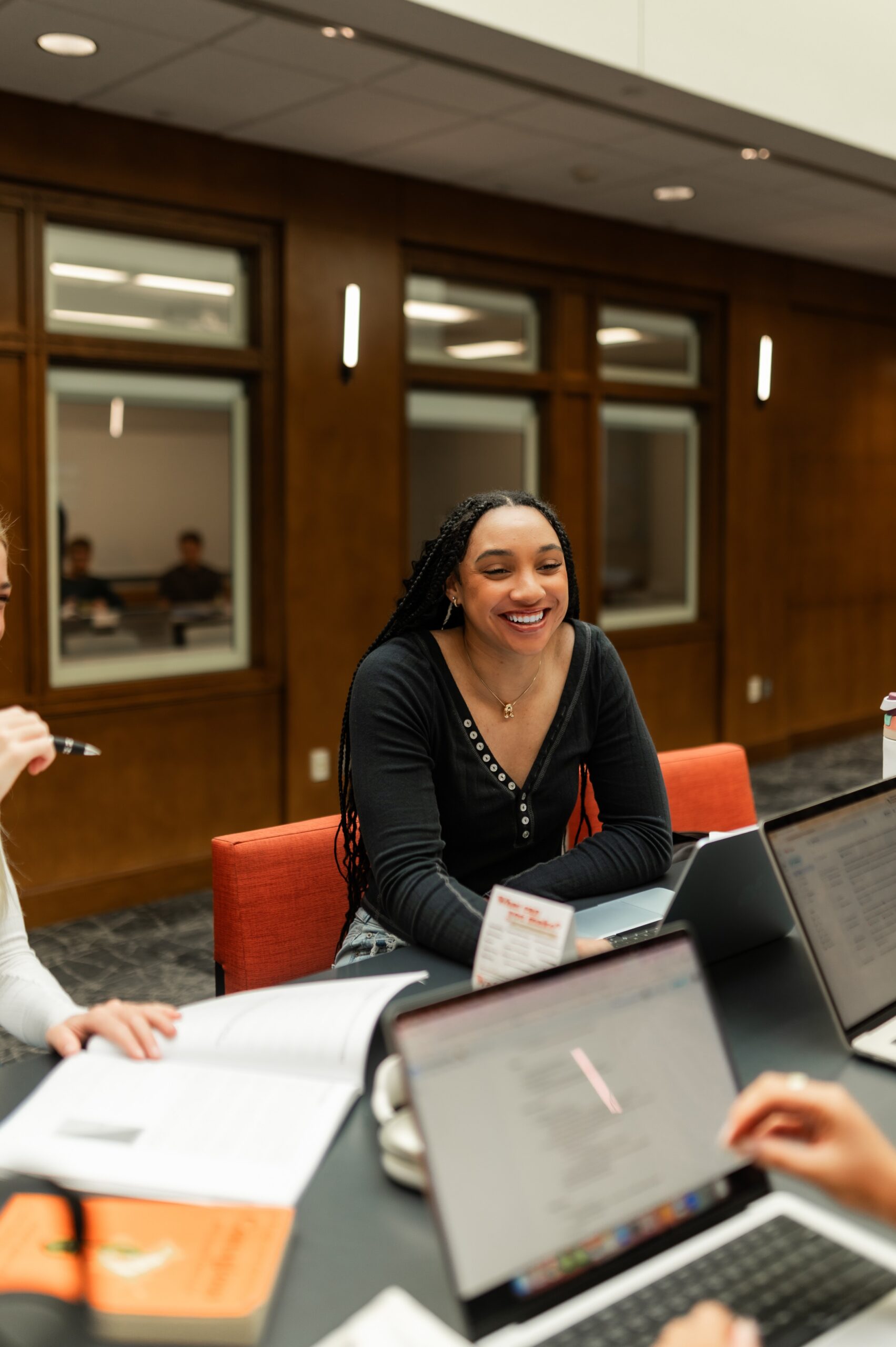 peers discussing assignments at library table scaled