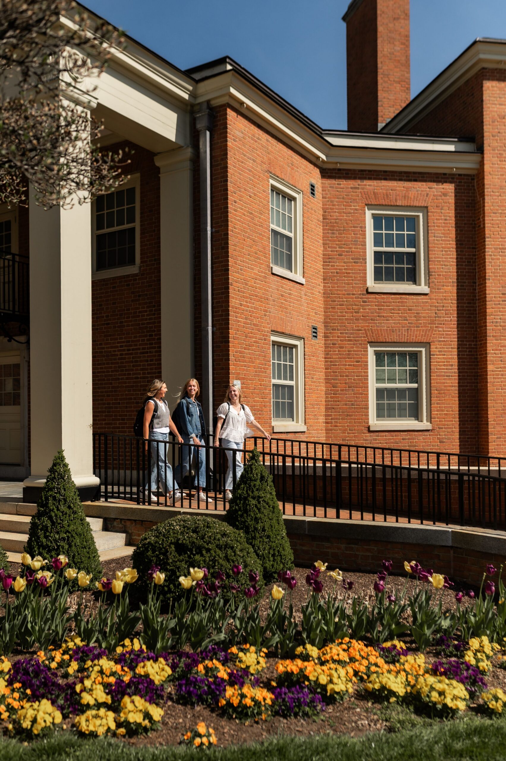 peers passing brick academic building exterior scaled