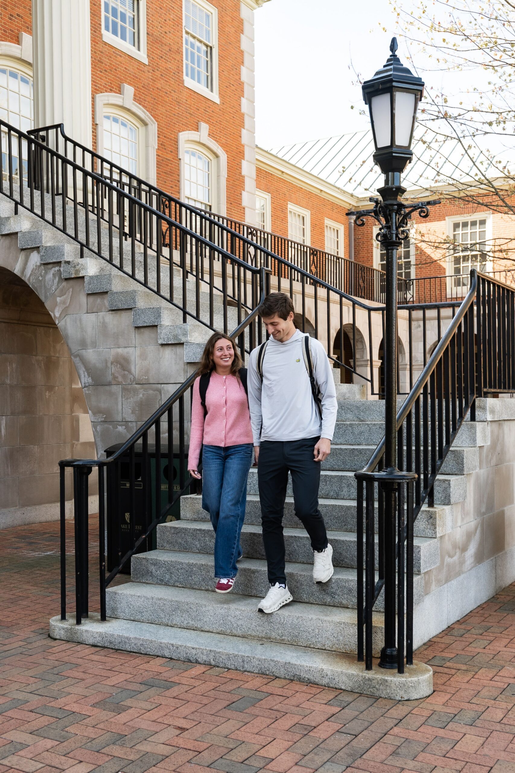 students descending campus stone staircase scaled