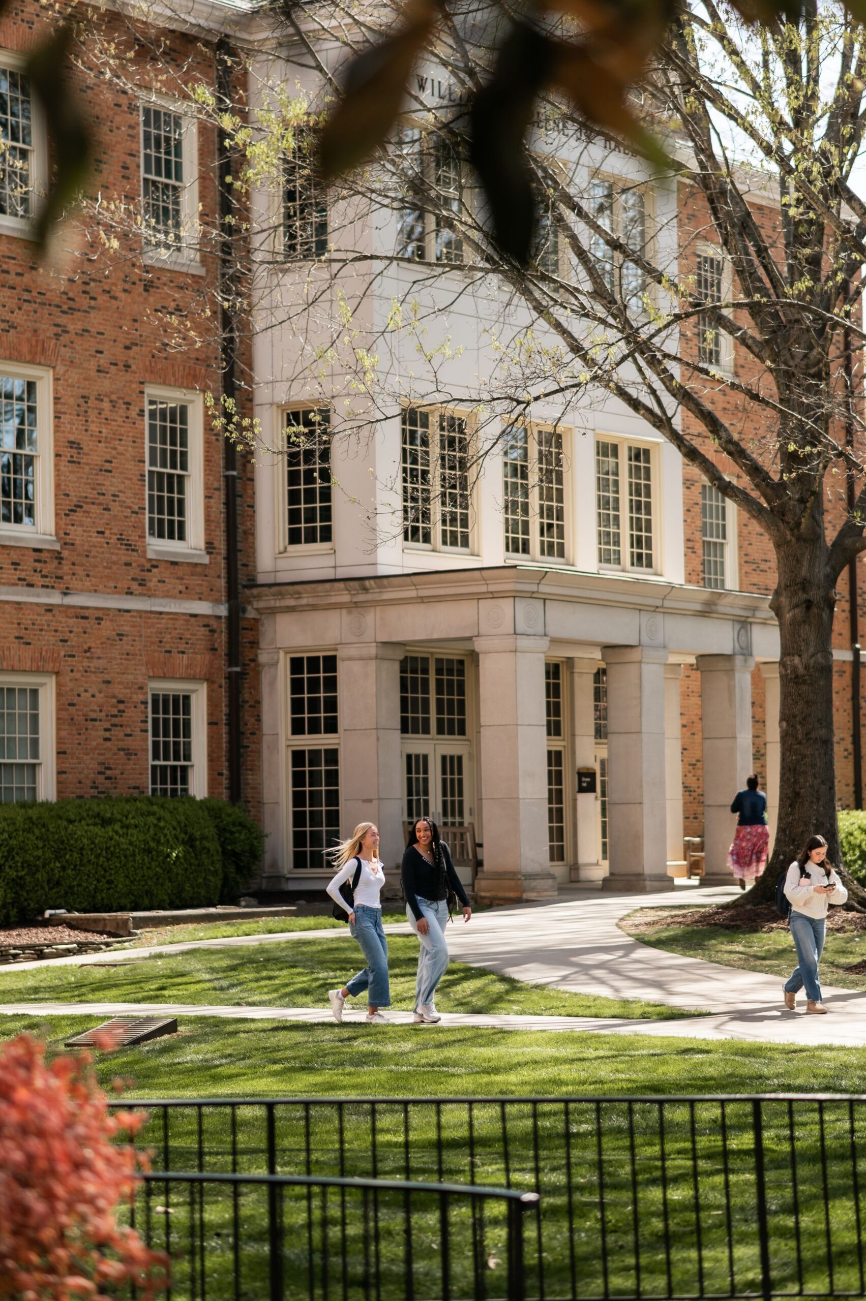 students walking past university hall scaled