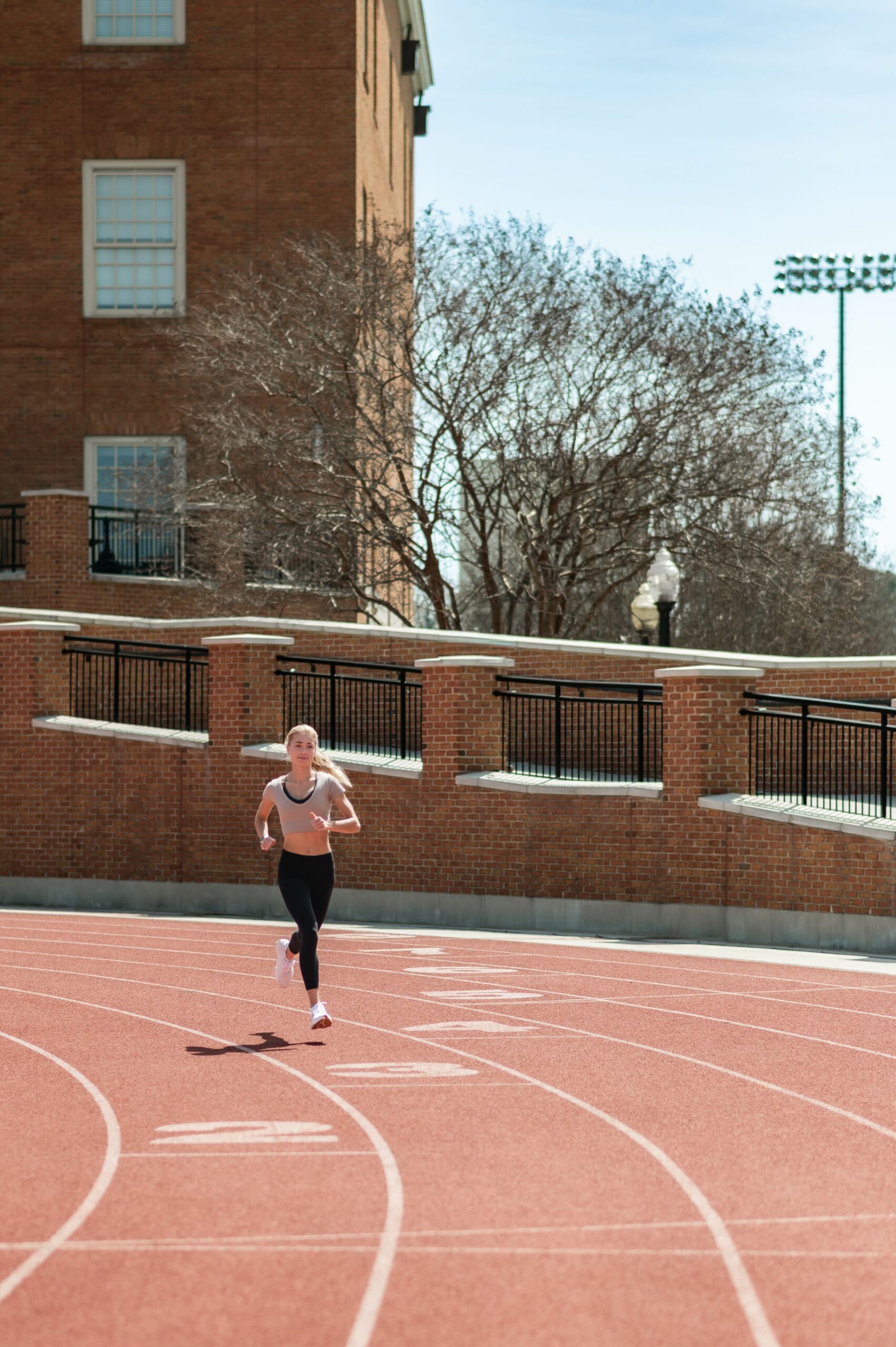 woman jogging on outdoor track scaled