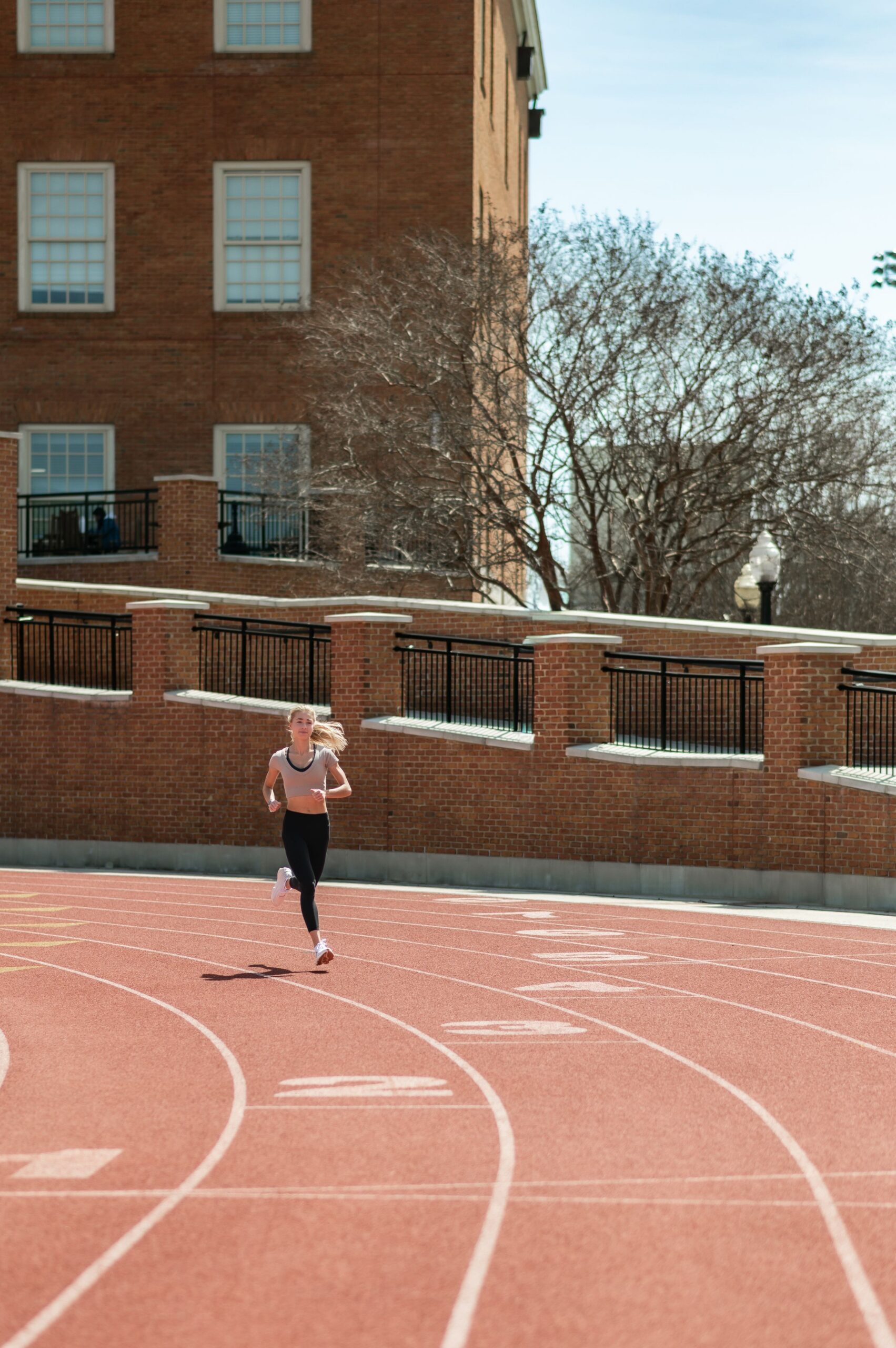 woman running on university track scaled