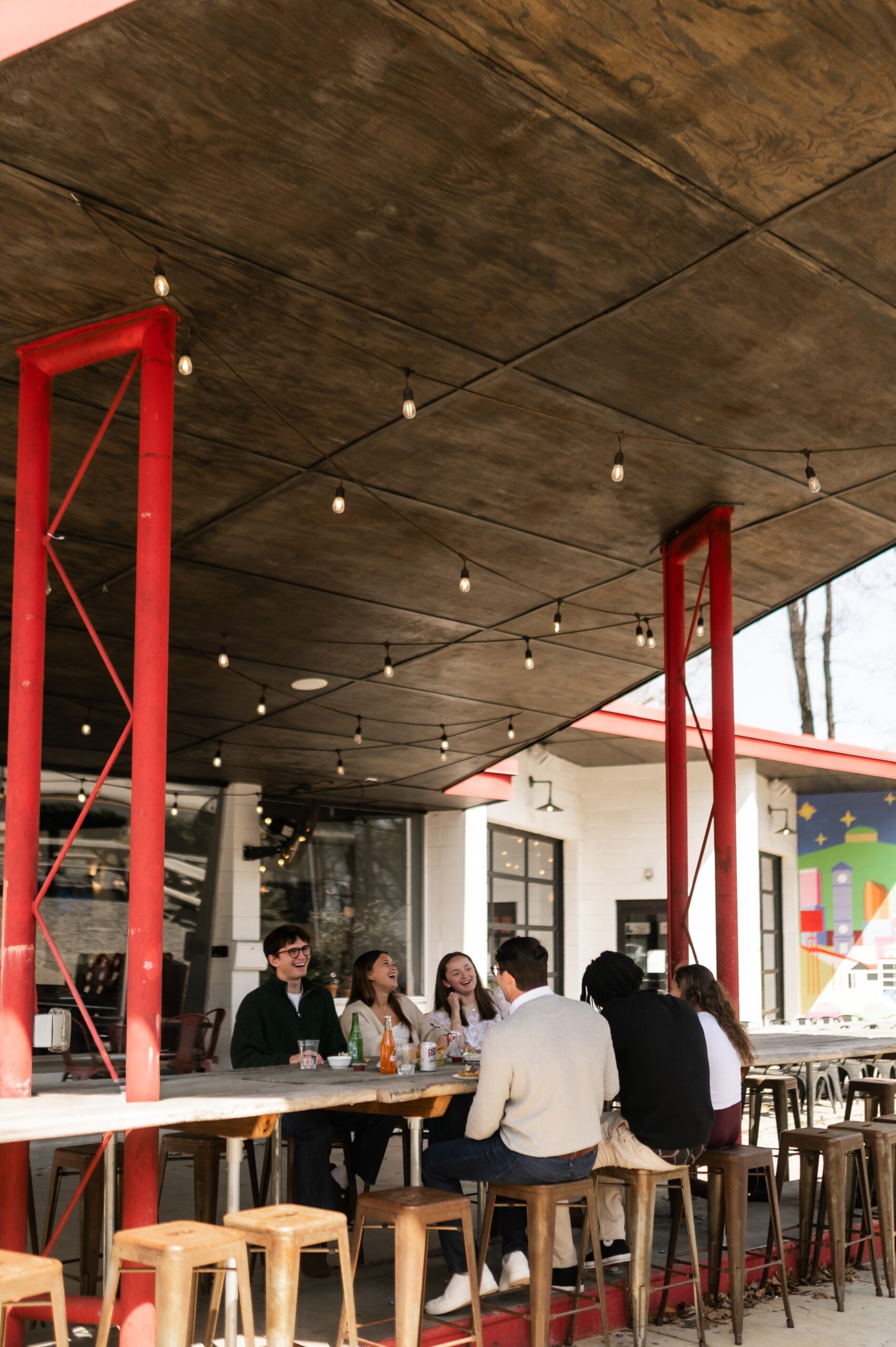 young adults dining at outdoor counter scaled